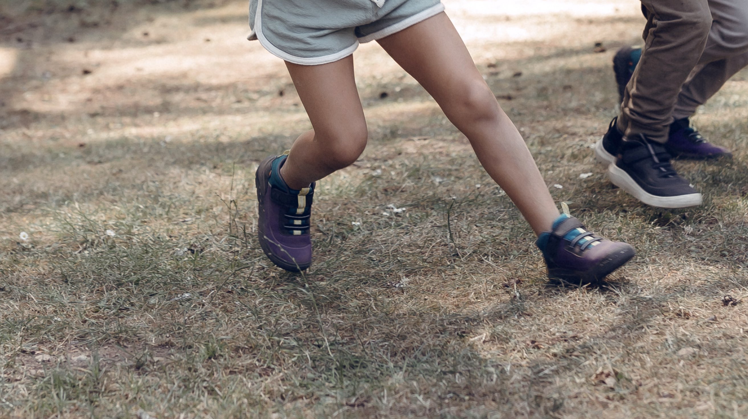 Shop our casual Kids' Skyline Kicker shoes.  The image shown is a waist down shot of a girl running. The boot highlighted our Kids' Skyline Kicker shoes in a variety of colors.