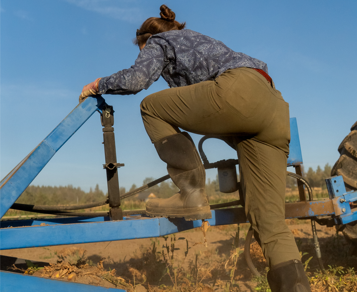 Shop our women's seamless boots.  The image shown is a farmer stepping on to a trailer wearing the Classic Seamless tall. 