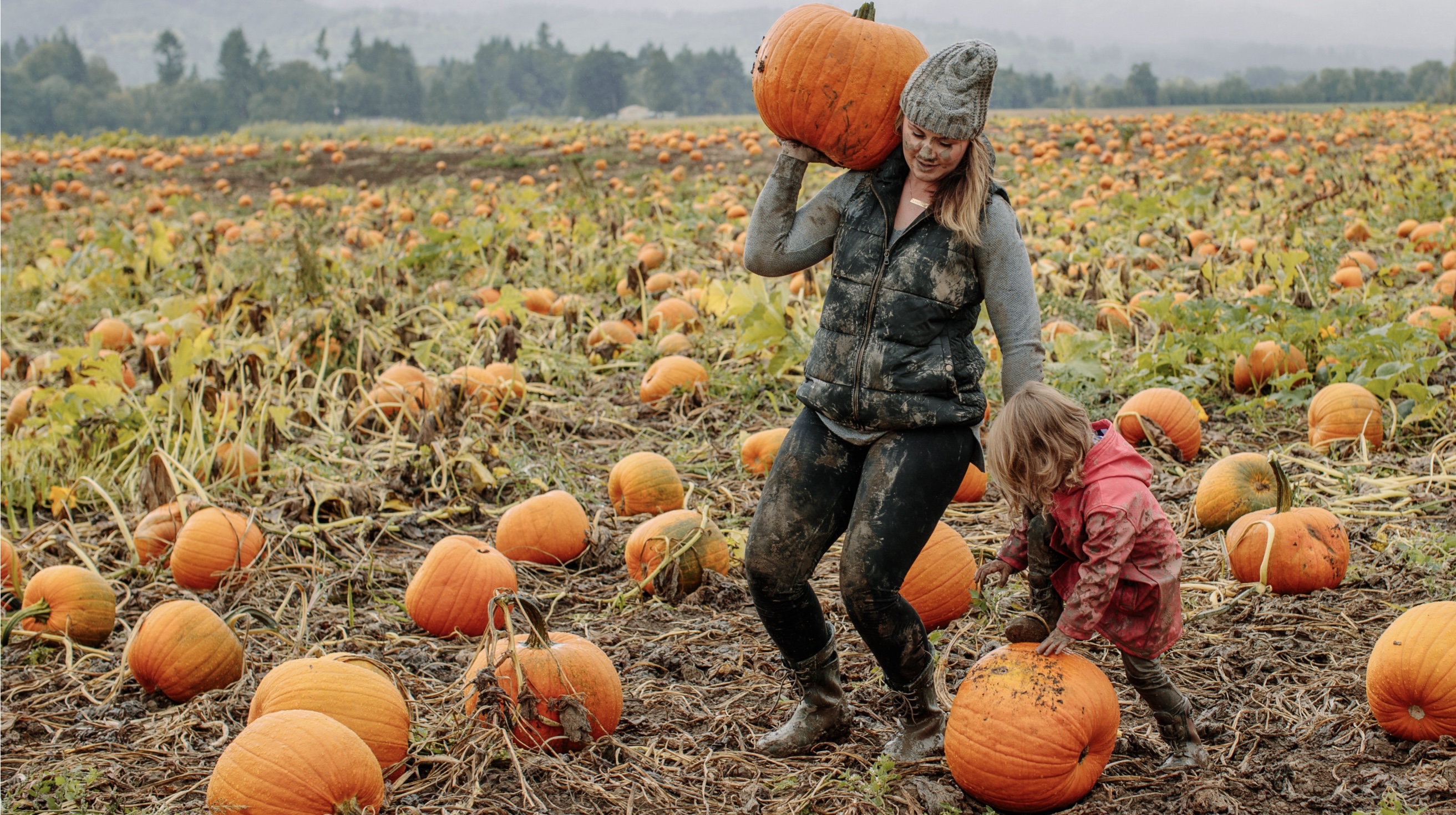 The image shown is a mom and wife in a muddy pumpkin patch.  Fall is officially here, get your pumpkin & shop our kids boots.