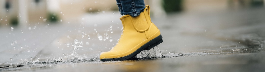 The image shown is our Women's Amanda II plush waterproof chelsea boot in mustard splashing in a puddle.  Shop now.